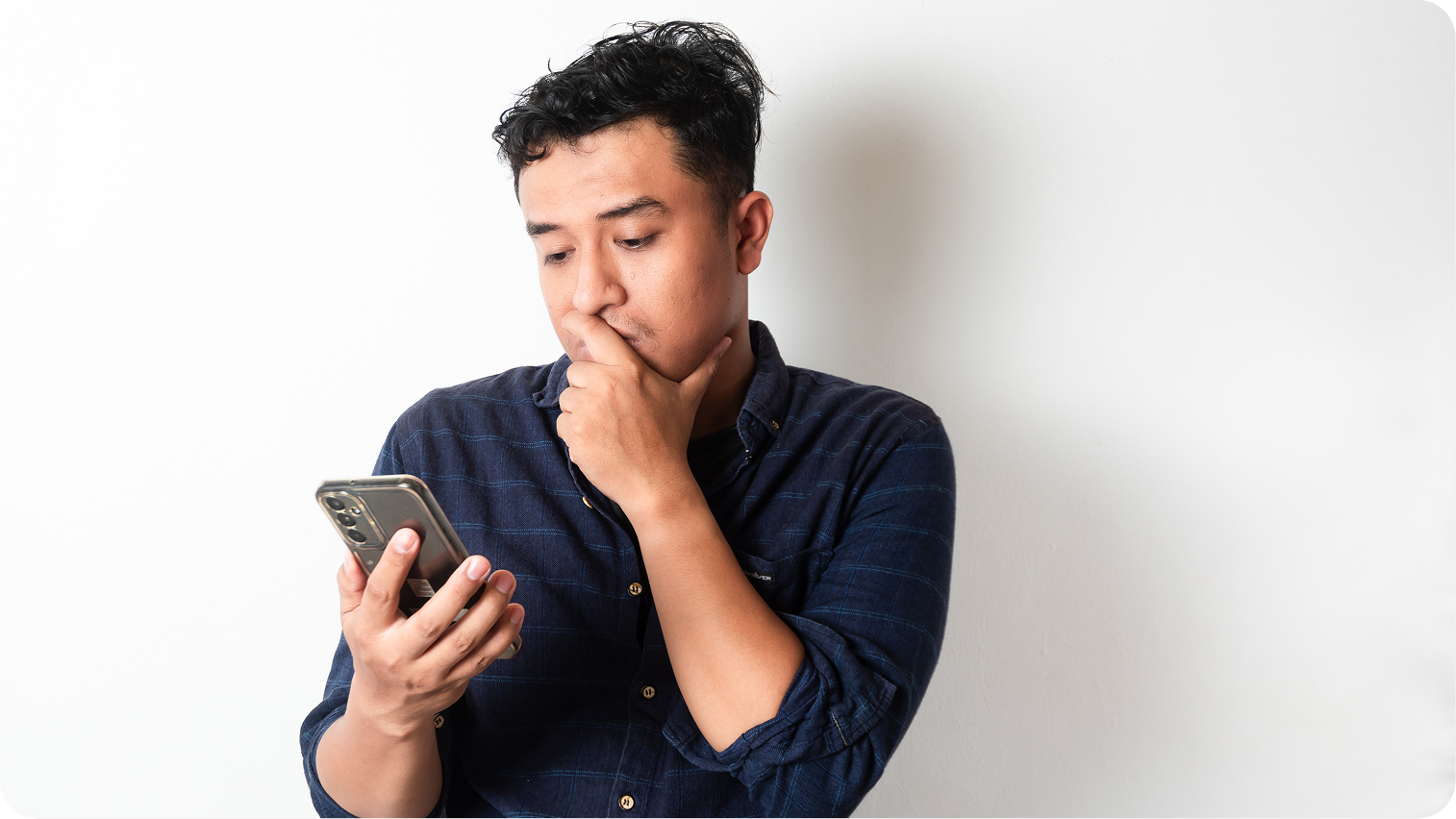 Pedro looking at his phone after touring Ashton Pointe